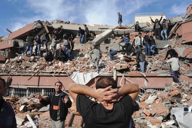 Rescue workers try to save people trapped under debris after an earthquake in Tabanli village near the eastern Turkish city of Van October 23, 2011.  REUTERS/Abdurrahman Antakyali/Anadolu Agency