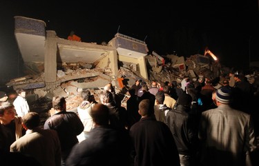 Rescue workers try to save people trapped under debris after an earthquake in Ercis, near the eastern Turkish city of Van, October 23, 2011. REUTERS/Osman Orsal