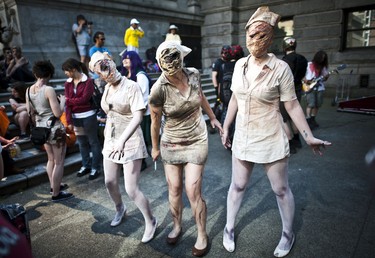 Three women zombie pose for picture in front of the Art Gallery as they get ready for the annual Zombie Walk in Vancouver, BC. Aug. 20, 2011. (CARMINE MARINELLI/QMI AGENCY)
