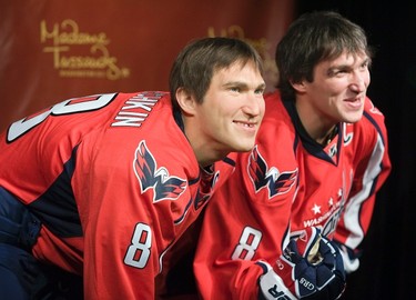 Russia's Alex Ovechkin (R), star forward for the Washington Capitals of the NHL, smiles with his wax likeness in hockey gear at Madame Tussauds wax museum in Washington on Oct. 24, 2011. (REUTERS)