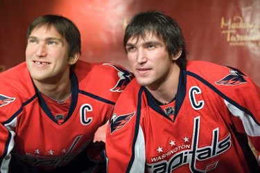 Russia's Alex Ovechkin (R), star forward for the Washington Capitals of the NHL, mimics his wax likeness in hockey gear during the unveiling at Madame Tussauds wax museum in Washington on Oct. 24, 2011. (REUTERS)