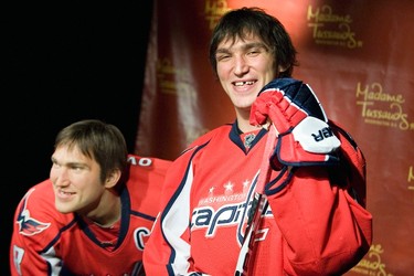 Russia's Alex Ovechkin (R), star forward for the Washington Capitals of the NHL, laughs at the unveiling of his wax likeness in hockey gear at Madame Tussauds wax museum in Washington on Oct. 24, 2011. (REUTERS)