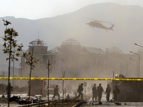 A NATO helicopter flies over the site of a bomb blast in Kabul in this October 29, 2011 file photo. REUTERS/Omar Sobhani