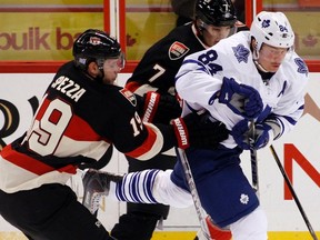 Maple Leafs forward Mikhail Grabovski narrowly avoids being hit by Ottawa Senators' Jason Spezza (left) and David Rundblad. (Reuters)