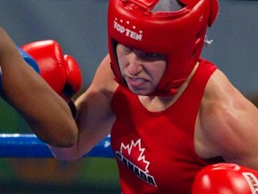 Amateur boxing is seeking opinions on whether female boxers -- like Canada's Pan Am gold medal winner Mandy Bujold -- should wear shorts or skirts at the Olympics next year. (REUTERS/Andy Clark)