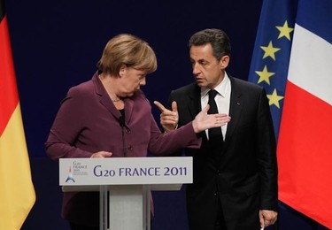 German Chancellor Angela Merkel (L) and French President Nicolas Sarkozy talk to each other prior to holding a joint press conference following crisis talks with Greece's Prime Minister in Cannes, southeastern France, on November 2, 2011 on the eve of the G20 Summit of Heads of State and Government.(AFP PHOTO/THOMAS COEX)