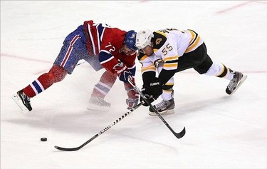 Montreal Canadiens left wing Erik Cole (72) and Boston Bruins defenseman Johnny Boychuk (55) battle for the puck during the first period at the Bell Centre. Jean-Yves Ahern/US PRESSWIRE)