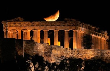 A crescent moon is seen over the Parthenon atop Athens' ancient Acropolis November 1, 2011. (REUTERS/Yannis Behrakis)