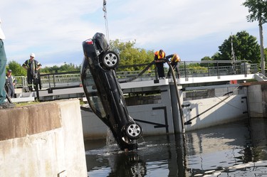 The Nissan Sentra, that contained the bodies of four Montreal women, is hoisted out of the Rideau Canal at Kingston Mills, Kingston, Ont. (Police Photo)
