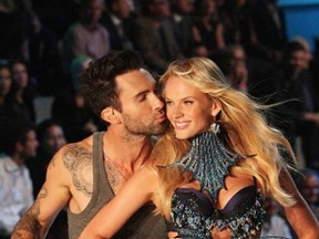 Adam Levine, lead singer of the group Maroon 5, kisses model Anne Vyalitsyna as she presents a creation during the Victoria's Secret Fashion Show at the Lexington Armory in New York November 9, 2011. (PNP/WENN.COM)