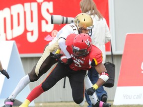 University of Manitoba safety Teague Sherman (seen tackling Calgary Dinos Anthony Woodson during an Oct. 22, 2011 Canada West university football game at McMahon Stadium in Calgary) is one of four Bisons hoping to have their names called at Wednesday's CFL Canadian Draft.