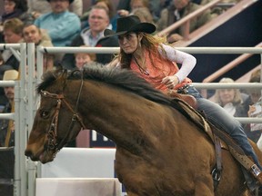 Gaylene Buff, from Westwold, B.C., competes in the barrel racing competition at the Canadian Finals Rodeo on the last day of competition held at Rexall Place on Sunday. 
Ian Kucerak, Edmonton Sun
