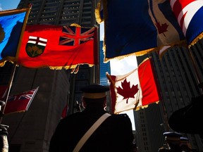 Veterans hold flags during the Remembrance Day ceremony in Toronto, November 11, 2011. REUTERS/Mark Blinch