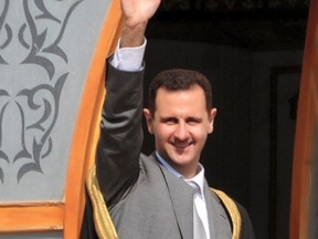 Syria's President Bashar al-Assad greets the crowd during his visit to Raqqa city in Eastern Syria, November 6, 2011. (REUTERS)