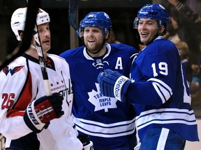 Toronto Maple Leafs forward Joffrey Lupul (right) celebrates his goal with forward Phil Kessel behind Washington Capitals forward Matt Hendricks  during Saturday night's big Leafs win at the ACC. (REUTERS)