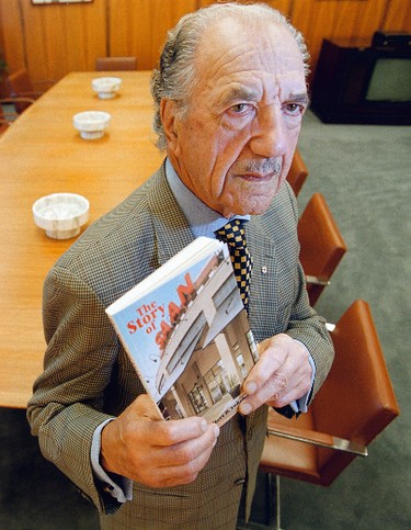 Chairman and CEO Albert Cohen holds a book he wrote about the SAAN store. (Winnipeg Sun files)