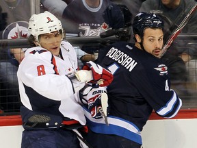 Washington Capitals left winger Alex Ovechkin (left) checks Winnipeg Jets defenceman Zach Bogosian. He's in trouble for a different hit, in Washington Nov. 23, 2011. (Winnipeg Sun files)