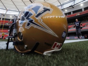 Winnipeg Blue Bombers defensive tackle Doug Brown jogs behind his helmet during practice in Vancouver, November 25, 2011.  The Winnipeg Blue Bombers will play the BC Lions at BC Place in the CFL's 99th Grey Cup football game this Sunday. REUTERS/Mark Blinch (CANADA - Tags: SPORT FOOTBALL)
