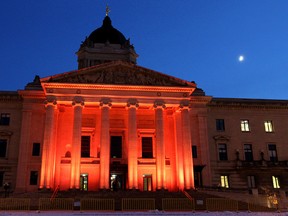The Manitoba Legislature is lit up orange in honour of the CFL Grey Cup champion B.C. Lions on Nov. 29, 2011. It was part of a bet Premier Greg Selinger lost to his B.C. counterpart Christy Clark when the Winnipeg Blue Bombers lost to B.C. on Sunday. Later in the evening, the lighting scheme was shifted to blue-and-gold in honour of the Bombers.
JASON HALSTEAD/WINNIPEG SUN QMI AGENCY