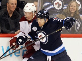 Coyotes forward and ex-Jet Shane Doan, seen getting checked by Jet’s Blake Wheeler, praised Winnipeg goalie Pavelec’s play. (BRIAN DONOGH/Winnipeg Sun)