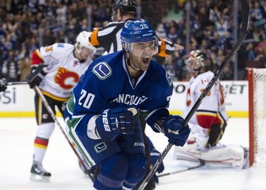 Chris Higgins of the Vancouver Canucks celebrates after scoring on goalie Henrik Karlsson of the Calgary Flames during the second period in NHL action on December 04, 2011 at Rogers Arena in Vancouver, British Columbia, Canada. (Rich Lam/Getty Images/AFP)