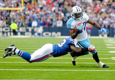 Tennessee Titans wide receiver Lavelle Hawkins (R) runs the ball as Buffalo Bills defensive back Bryan Scott (L) wraps him up in the third quarter of their NFL football game in Orchard Park, New York December 4, 2011. (REUTERS/Doug Benz)