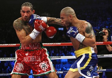 Miguel Cotto from Puerto Rico (R) lands a right hand to the head of Antonio Margarito from Mexico during their WBA World Junior Middleweight championship boxing match at New York's Madison Square Garden, December 3, 2011. Cotto retained his title with a technical knockout in the ninth round after the referee stopped the fight. (REUTERS/Mike Segar)