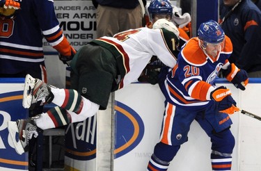 Minnesota Wild's Darroll Powe runs into an open gate after getting hit by Edmonton Oilers' Eric Belanger during the second period of their NHL hockey game in Edmonton November 30, 2011. (REUTERS/Dan Riedlhuber)