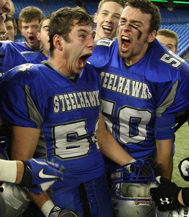 Superior Heights player #54 Chris Boudreau and #50 Ryan Anich celebrate after winning the Northern Bowl in Toronto November 29, 2011. The Northern Bowl saw the Superior Heights C&VS (Sault Ste.  Marie) vs Sir Winston Churchill C&VS (Thunder Bay ) Superior Heights won 34-28. (CRAIG ROBERTSON/QMI Agency)
