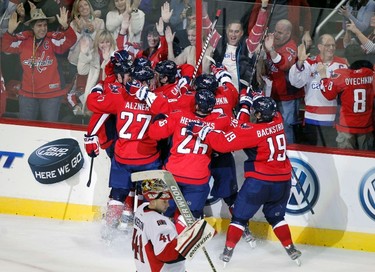 Washington Capitals players celebrate the game winning goal by Brooks Laich (21) against the Ottawa Senators in overtime of their NHL hockey game in Washington December 3, 2011. (REUTERS/Molly Riley)