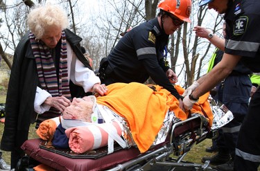 Gene St. Marie, 89, was using a wheelbarrow to clean up the leaves in his backyard when he fell over the Scarborough Bluffs Sunday. Toronto Fire, police and EMS came to the rescue. Gene's 88-year-old wife, Kay, greets him. (Craig Robertson/Toronto Sun)