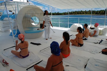 Guests start their Dr. Fish Spa Boat experience with some light yoga. (Ocean Adventures photo)