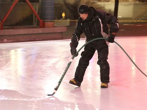 Forks employee Lennon Bastien floods the skating rink at the Forks in Winnipeg Monday Dec. 5, 2011. The rink is scheduled to open to the public later in the week. (BRIAN DONOGH/Winnipeg Sun)