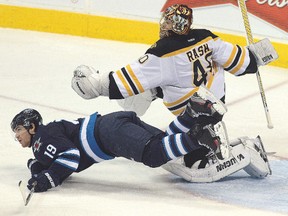 Jets centre Jim Slater gets tripped up with Bruins goalie Tuukka Rask Tuesday night. Unlike your typical Cup champions, the Bruins have slept off their hangover. Unfortunately for them, the Jets saw to it that they would leave Helm/AFP-Getty images(
