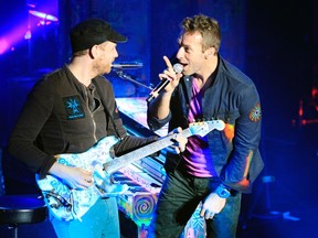 Lead singer Chris Martin, right, Jonny Buckland and the rest of Coldplay will perform at Rexall Place in April. (REUTERS/File)