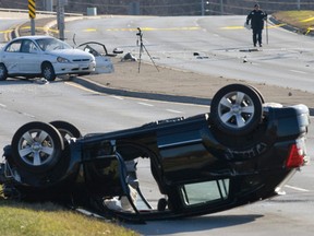 Police investigate the scene of a two-car crash that killed one man west of Toronto. (DAVE THOMAS/ QMI Agency)