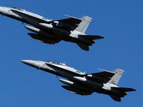 Two CF-18 fighter jets complete a fly past during the Battle of Britain ceremony at the Canadian Space and Aviation Museum Sunday, Sept. 18, 2011. (DARREN BROWN/QMI AGENCY)