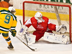 \U of A Golden Bears Johnny Lazo scores on Team Denmark goaltender Dennis Jensen during hockey action Friday at Clare Drake arena. (Amber Bracken, Edmonton Sun)