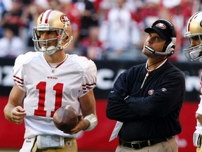 San Francisco 49ers quarterback Alex Smith (left) and head coach Jim Harbaugh talk in the fourth quarter of their NFL game against the Arizona Cardinals in Glendale, Ariz., Dec. 11, 2011.(Rick Scuteri/Reuters)