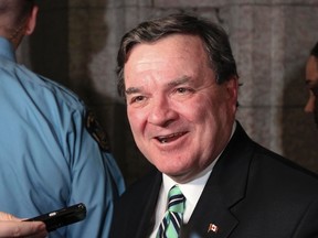 Finance Minister Jim Flaherty speaks to reporters as he leaves the House of Commons in Ottawa on Dec. 15, 2011. (ANDRE FORGET/QMI Agency)