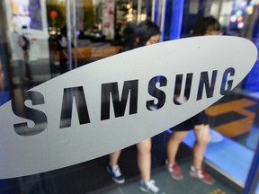 Students walk out of a showroom at the headquarters of Samsung Electronics in Seoul October 28, 2011. (REUTERS/Jo Yong-Hak)