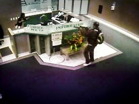 Patrick Clayton, the man who took nine people hostage at the Workers Compensation Board building Oct. 21, 2009 is seen in this security surveillance video frame grab entering the building with a rifle at the start of the incident.  (Security Surveillance Video Frame Grab)