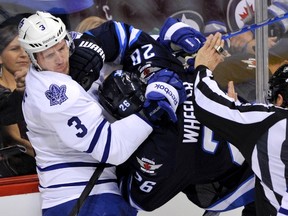 Toronto Maple Leafs' Dion Phaneuf (L) grabs Winnipeg Jets' Blake Wheeler during the first period of their NHL hockey game in Winnipeg December 31, 2011. (REUTERS/Fred Greenslade)