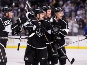 Vancouver Canucks' Andrew Alberts (R) comes over to confront Los Angeles Kings' Trevor Lewis (L-R), Brad Richardson, Matt Greene and Jack Johnson, as they celebrate Matt Greene's goal during the second period of an NHL hockey game in Los Angeles December 31, 2011.  (REUTERS/Danny Moloshok)