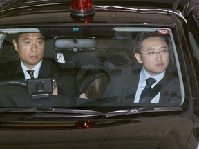 Makoto Hirata (C), a former leading member of Aum Shinri Kyo cult who has been on the run for more than 16 years, is escorted by police officers from a police station to another police station in Tokyo in this photo taken by Kyodo on January 1, 2012. Hirata, a former member of a Japanese doomsday cult that staged deadly gas attacks on the Tokyo subway in 1995, turned himself in to authorities after more than 16 years on the run, the Kyodo news agency reported on Sunday. Mandatory Credit.  REUTERS/Kyodo