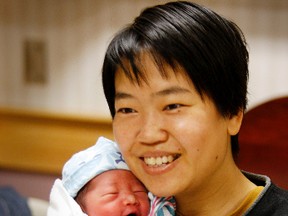 Li Zhang, 33, with baby Ming Shui Lei, who was born 40 seconds after midnight on Sunday.