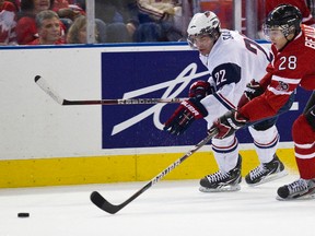 Canada defenceman Nathan Beaulieu chaes USA forward Brandon Saad during a World Junior Hockey Championship match at Rexall Place in Edmonton, Alta., Dec. 31, 2011. (CODIE McLACHLAN/QMI Agency)