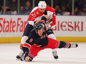 Panthers forward Krys Barch throws Rangers forward Brandon Prust to the ice at Madison Square Garden in New York, N.Y., Dec. 11, 2011. (MIKE STOBE/Getty Images/AFP)