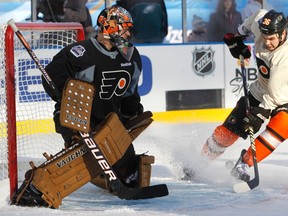 Flyers forward Zac Rinaldo takes a shot on goaltender Ilya Bryzgalov during practice at Citizens Bank Park in Philadelphia, Penn., Jan. 1, 2012. (TIM SHAFFER/Reuters)