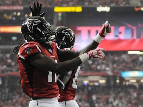 Falcons wide receiver Julio Jones (left) celebrates a touchdown against the Bucaneers with teammate Harry Douglas in Atlanta, Ga., Jan. 1, 2012. (TAMI CHAPPELL/Reuters)